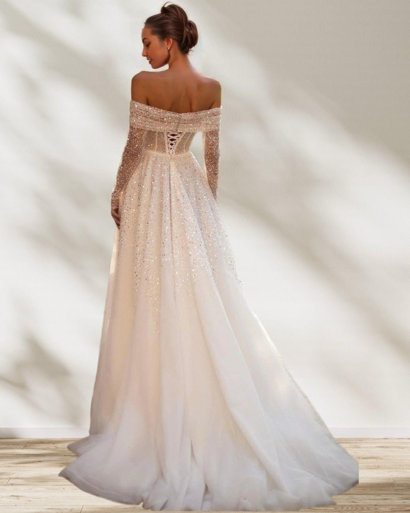 Bride from back posing in shimmering sequined dress with lace up back.