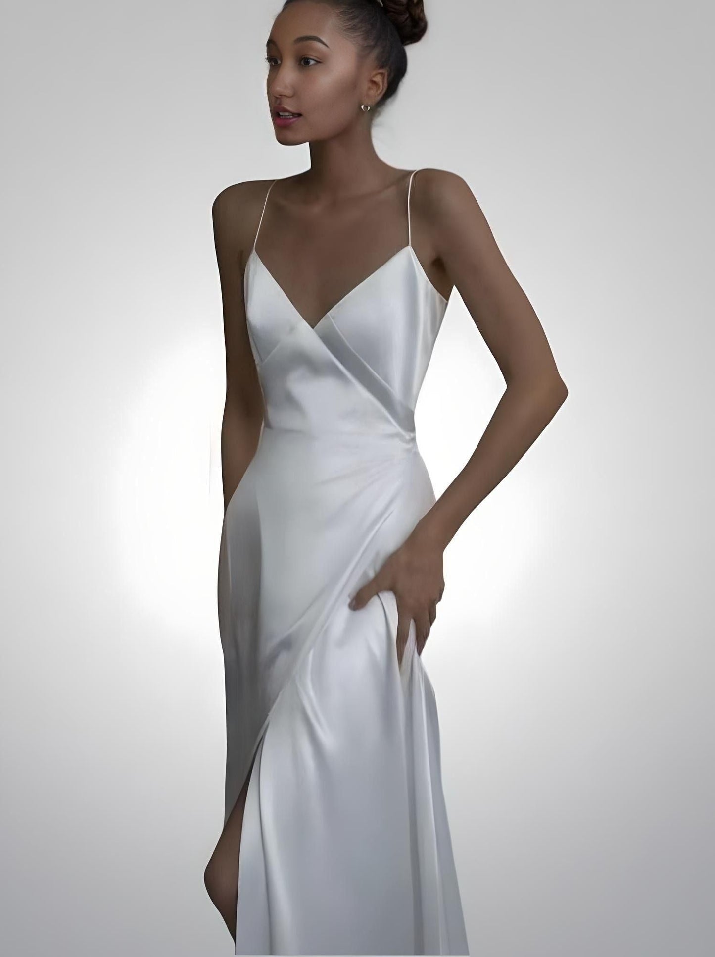 Bride in V-neckline wedding dress with spaghetti straps