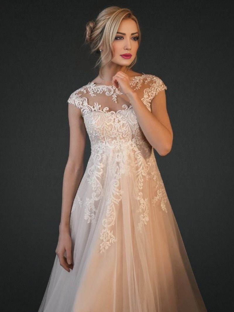 Bride showing lace illusion top detail of maternity plus size wedding dress