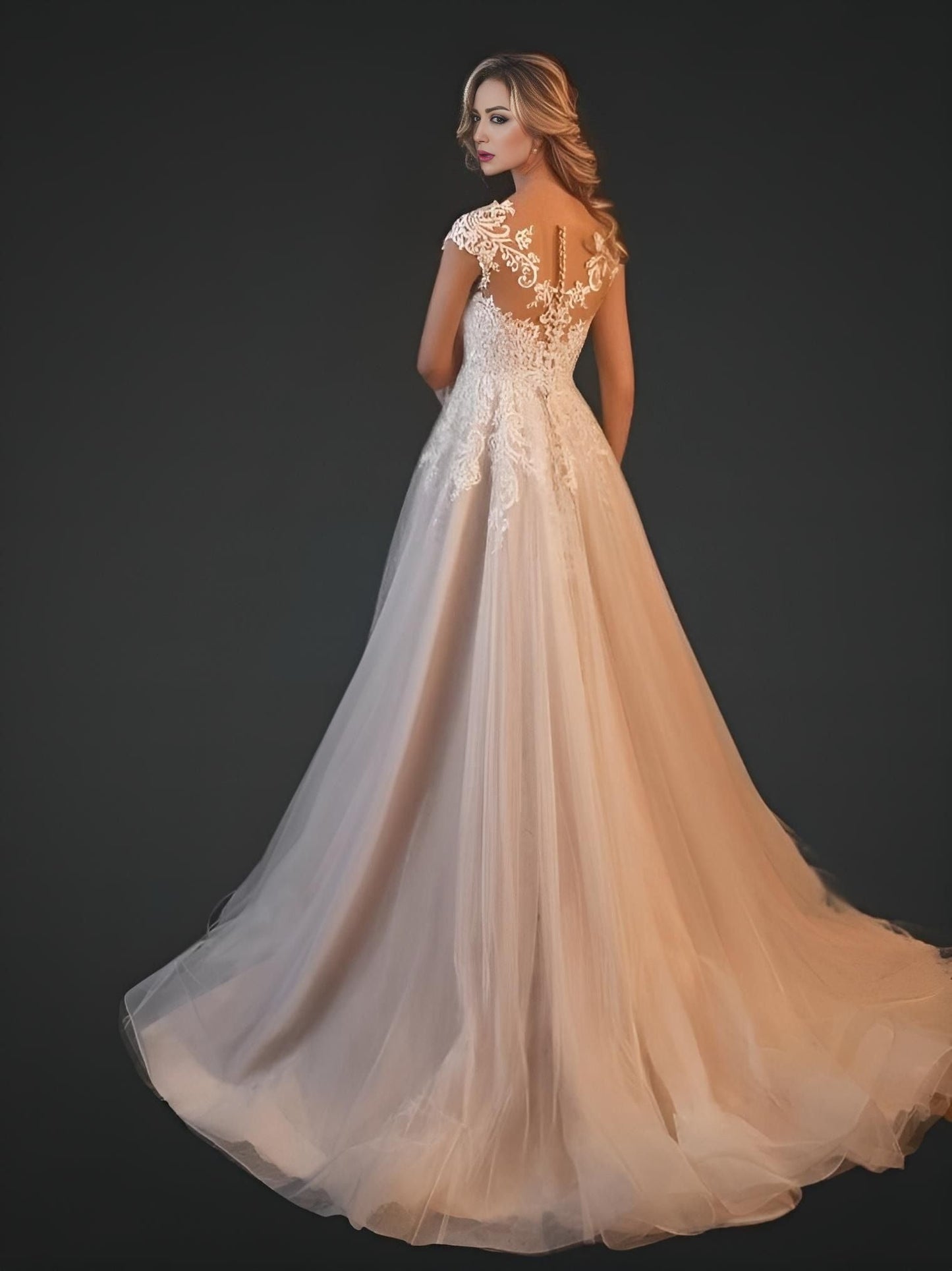 Bride in long gown from back, showing lace illusion top mesh with button back closure and sweep train