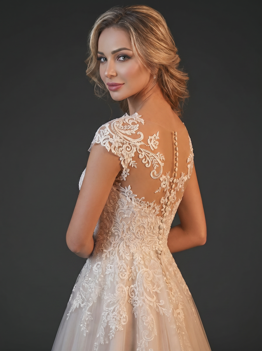Bride showing lace idetail illusion top mesh with button back closure