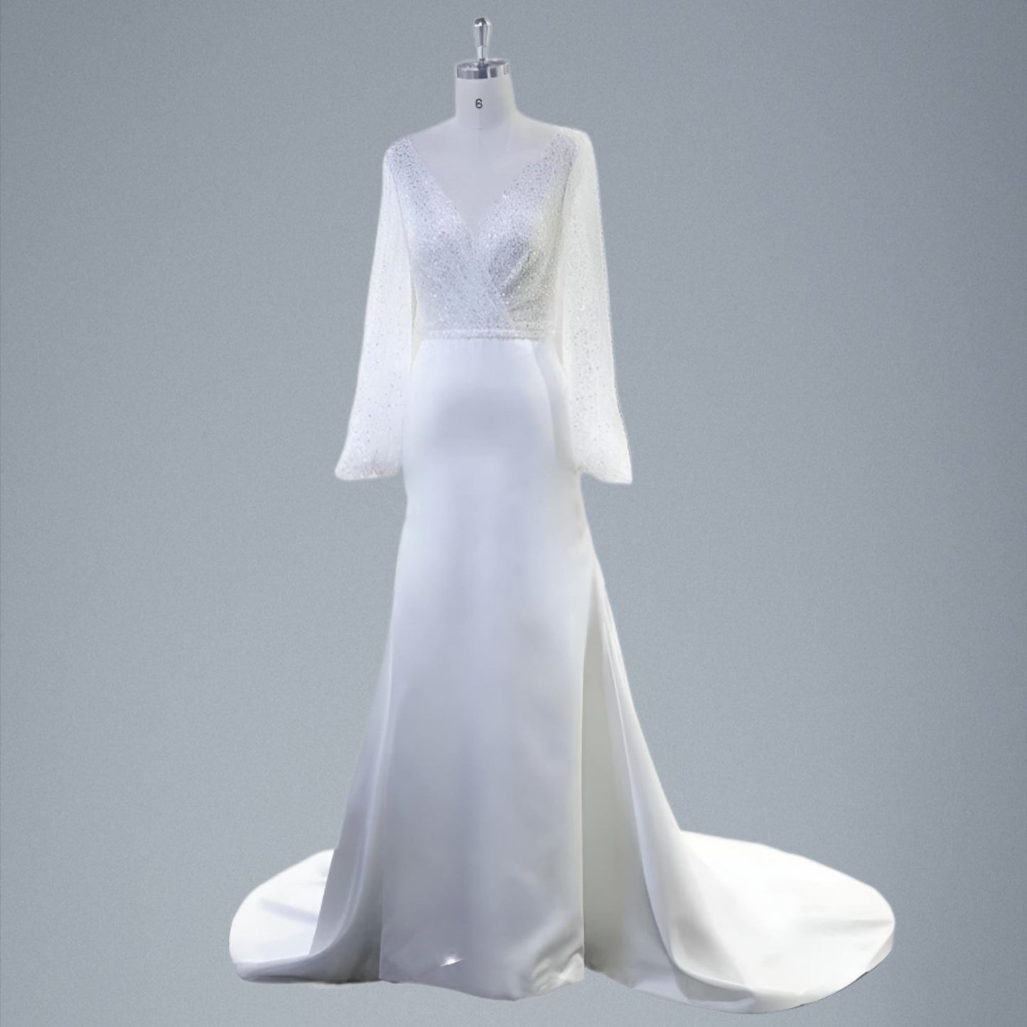 Figurine with a fully sequined lace top wedding dress with a pleated V neckline, mermaid satin skirt, complemented by a sexy deep V-neck and a high slit.