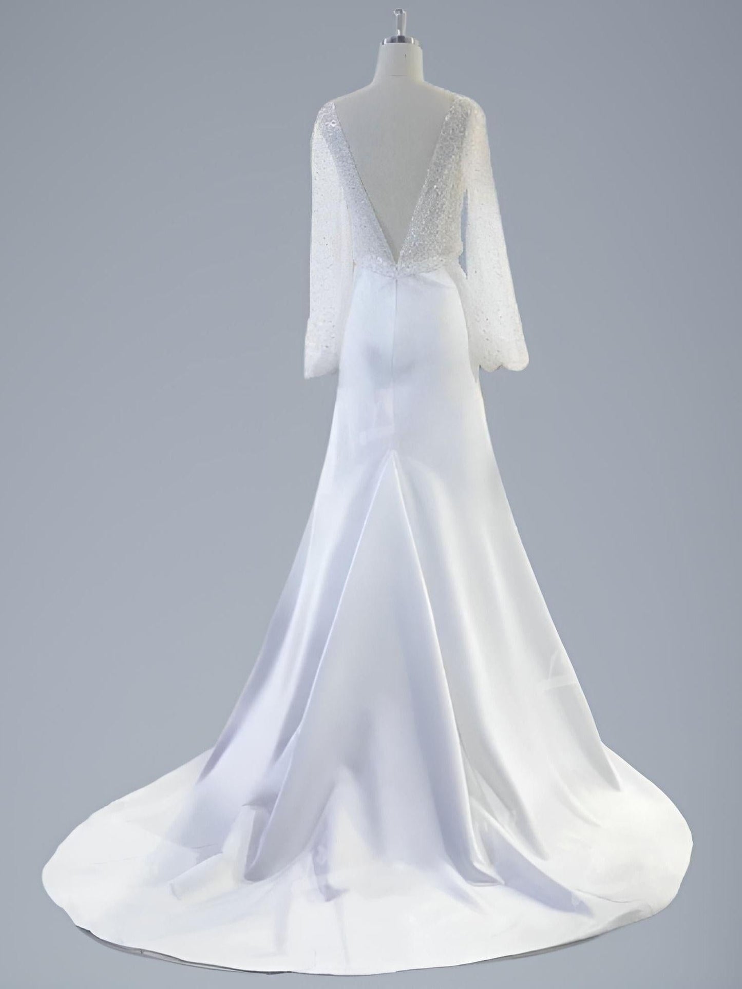 Backless of a wedding dress, deep V Back and satin mermaid skirt.