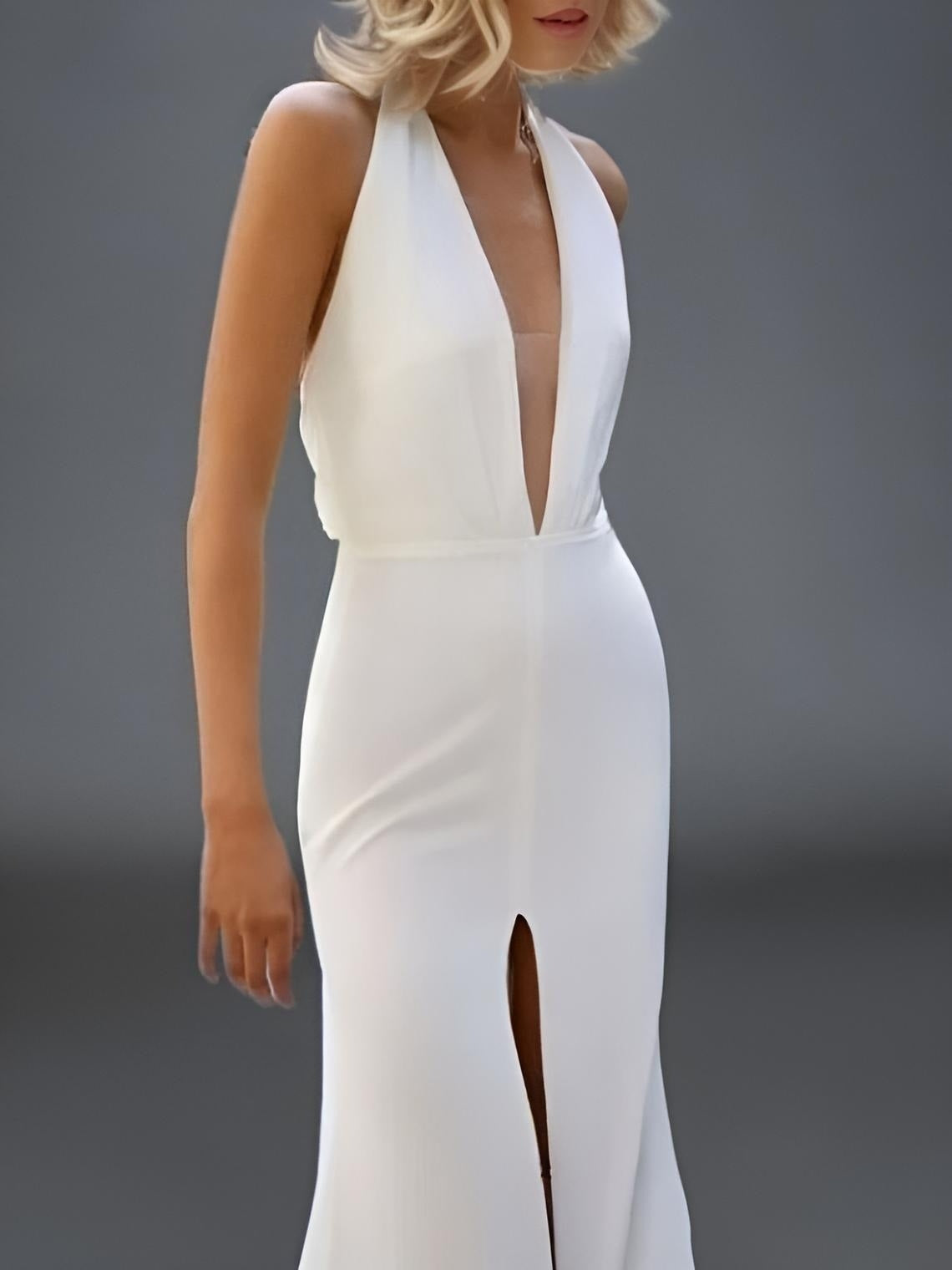 Detail of women wearing wedding gown with deep V neckline and front high split