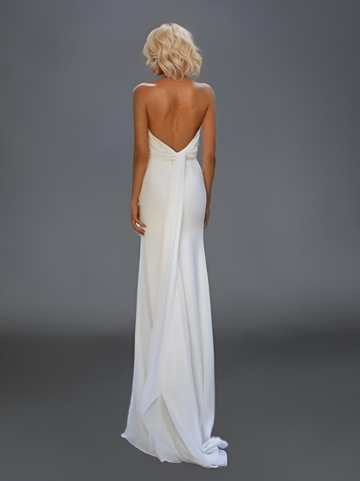 woman in backles simple bridal gown with low back bow watteau train detail