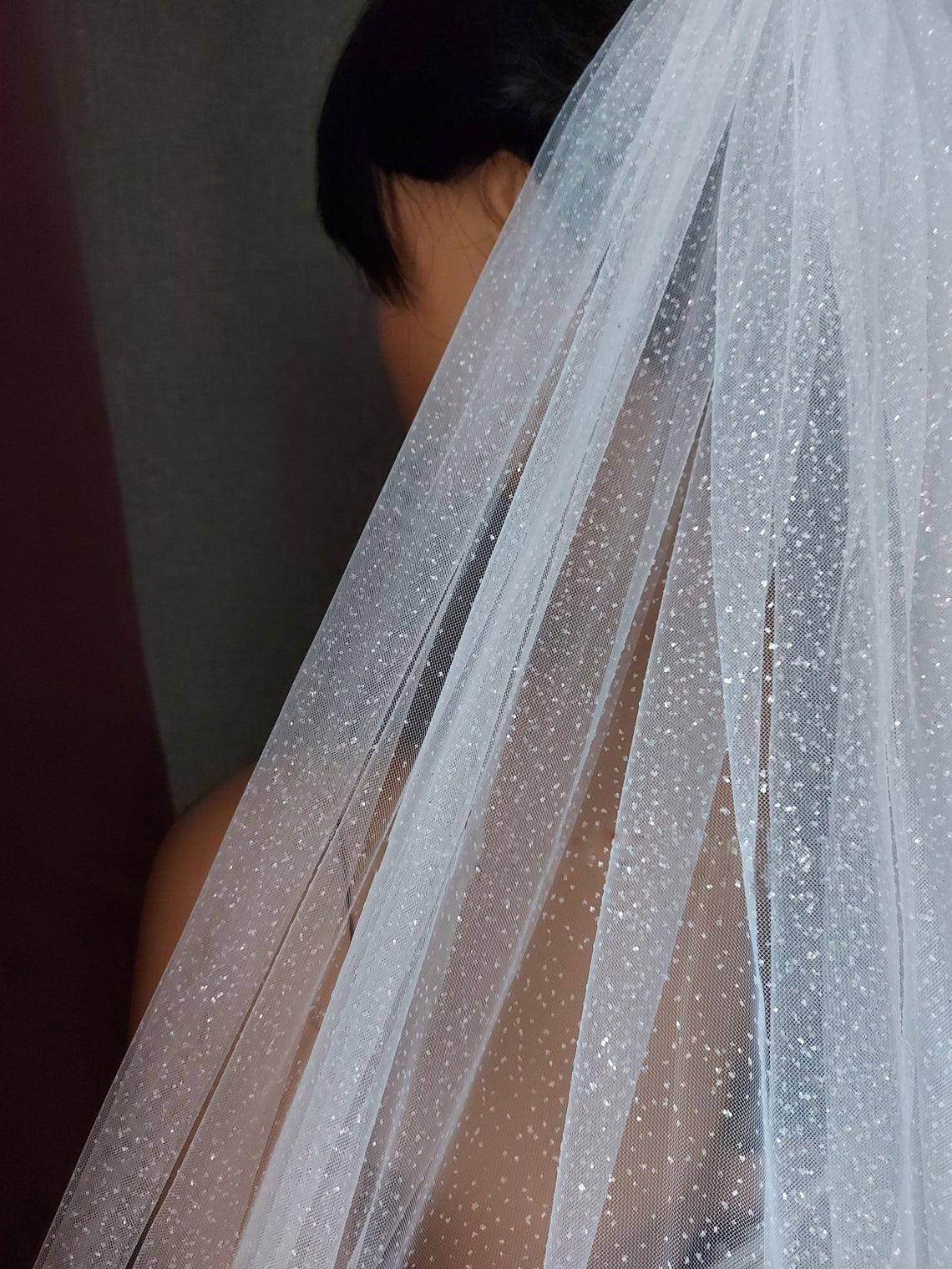 Bride with sparkling Wedding Veil in her hair from back- Bridal