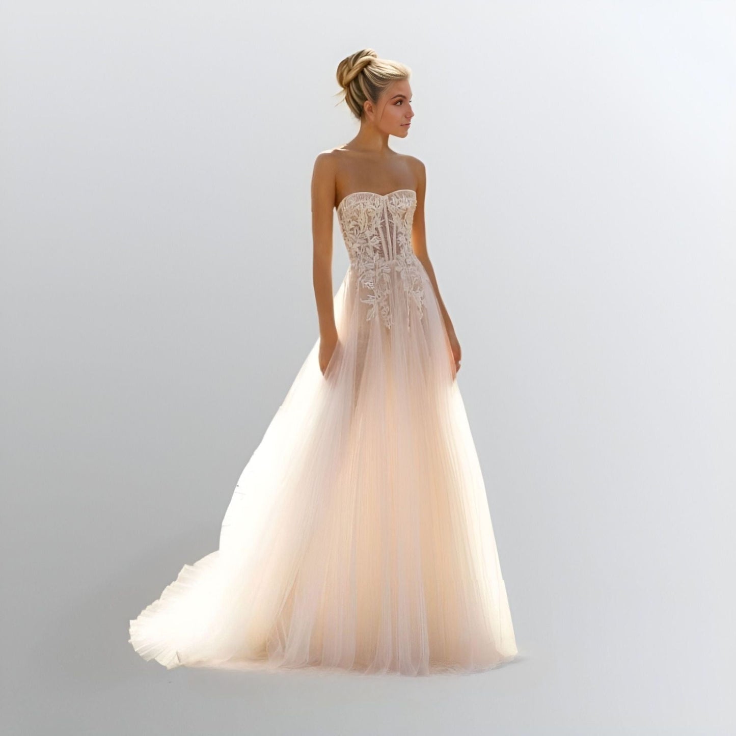 Model in Strapless A-Line Wedding Dress: A bride wearing the HARPER gown, highlighting the strapless A-line silhouette with lace appliques placed on the bust and sides.