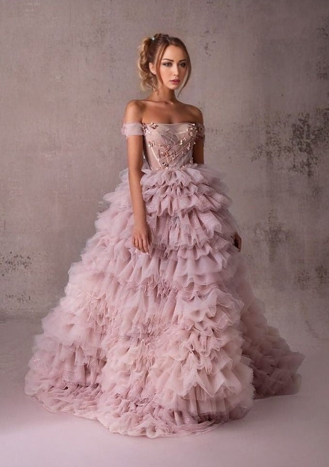 Elegant Pink Gown in Motion: A dynamic shot of the model walking, showing the flow of the tiered layers and the elegance of the gown.