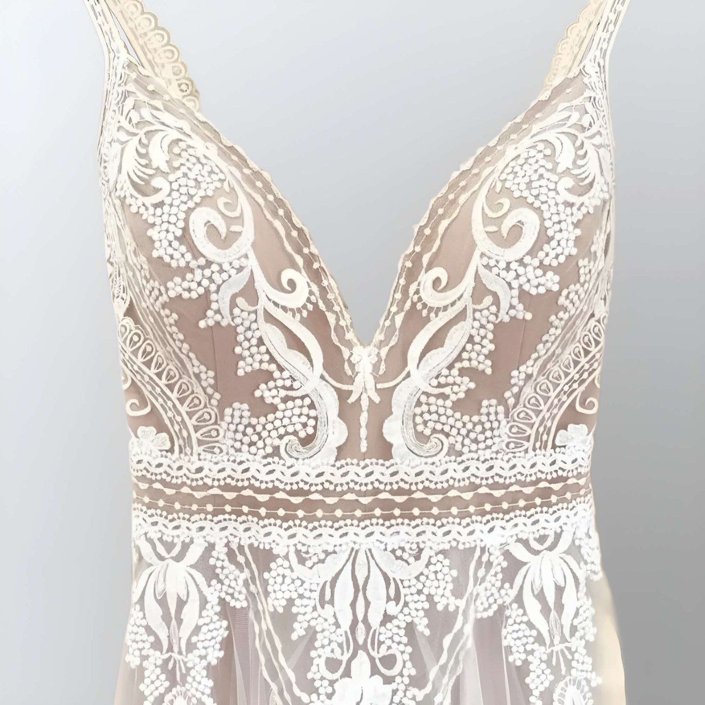 Romantic Lace Appliques on Tulle: A detailed shot of the lace appliques on the tulle fabric, showcasing the intricate craftsmanship and bohemian elegance.