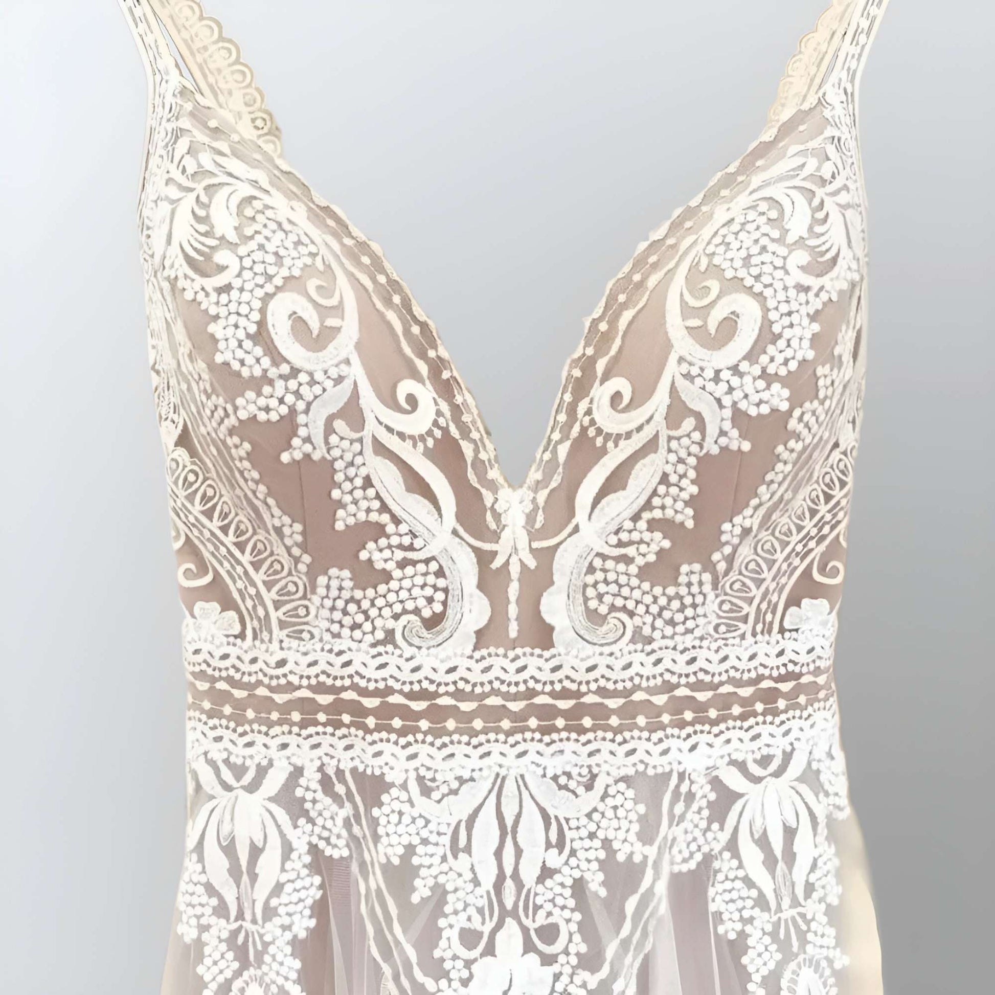 Romantic Lace Appliques on Tulle: A detailed shot of the lace appliques on the tulle fabric, showcasing the intricate craftsmanship and bohemian elegance.