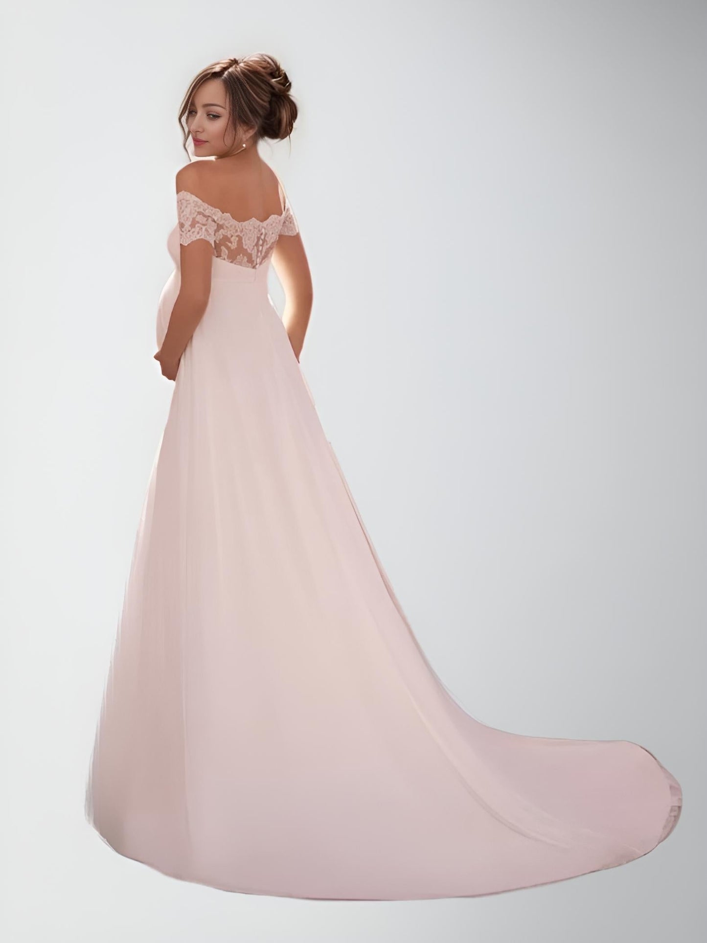 Back View of Button-Back Wedding Gown: The bride turned away, showcasing the button-back design and the flow of the sweep train.