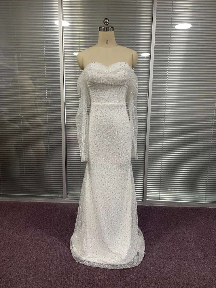 Elegant gown with full sequins, long off-the-shoulder sleeves.