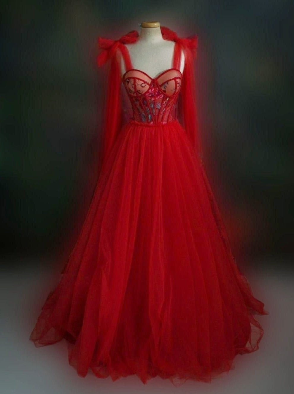 Elegant bright red gown featuring a sweetheart neckline, bow straps, and red tulle skirt with lace-up back.