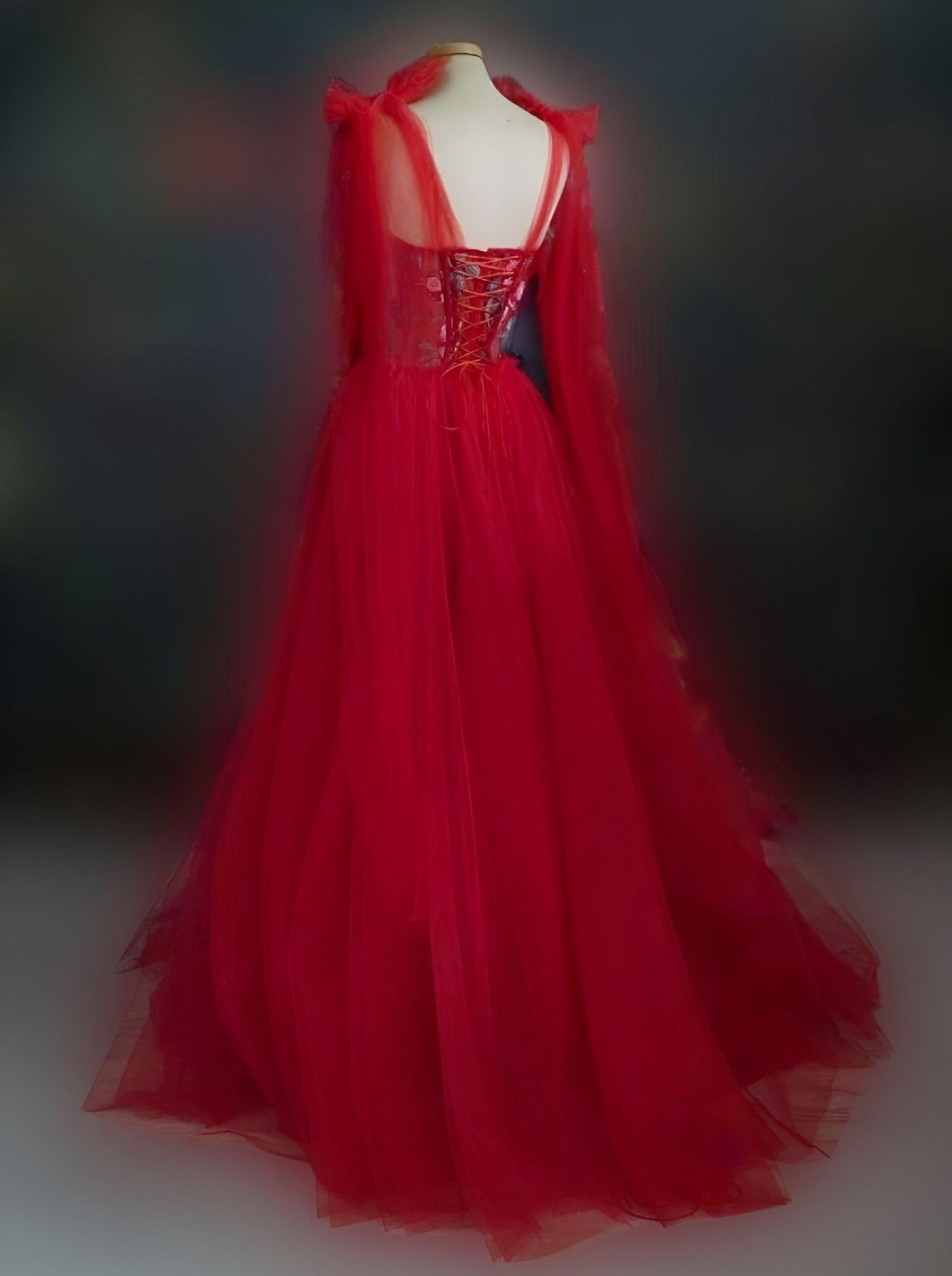Back detail of radiant red gown with red boning, floral appliques, and a lace-up back, ideal for formal and wedding events.