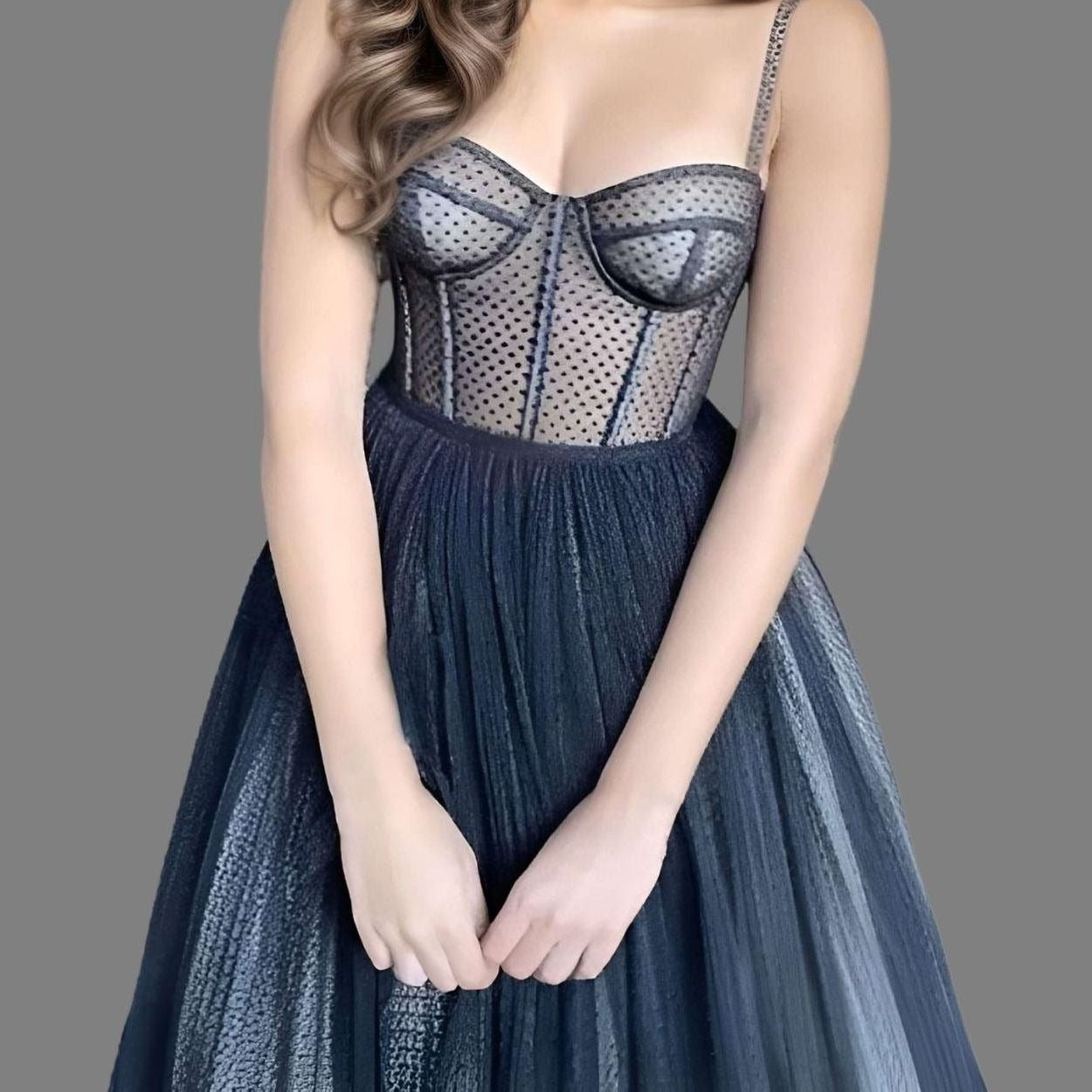 Stunning black corset A-line dress featuring dotted tulle, spaghetti straps, and boning, ideal for prom or weddings.