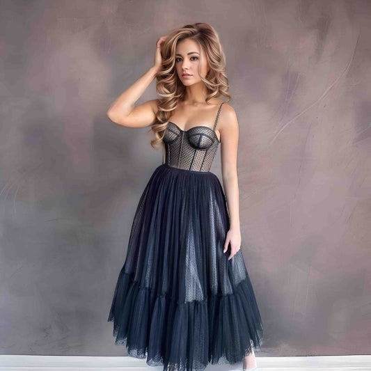 Elegant midi gown with a corset top, spaghetti straps, and tea-length dotted tulle skirt, perfect for formal events.