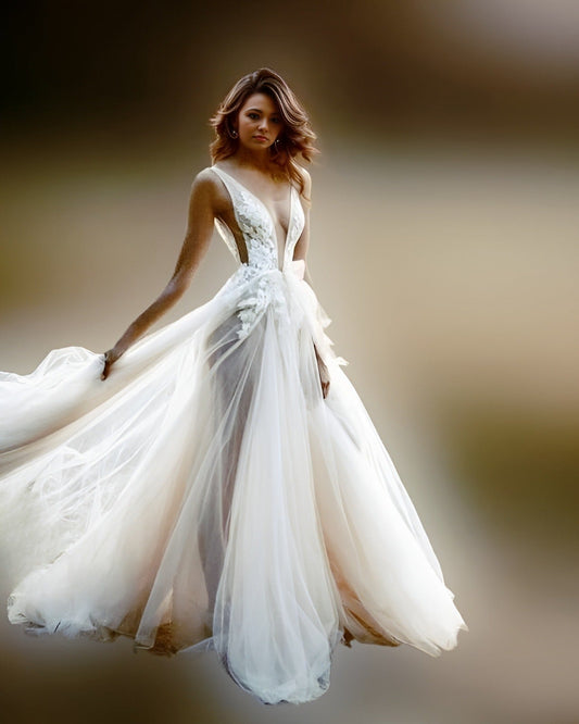 Model in a deep V-neck wedding dress with  side cutouts,showing her leg via see trough skirt.
