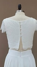Back detail of wedding dress lace top with short lace sleeves, and back opening.