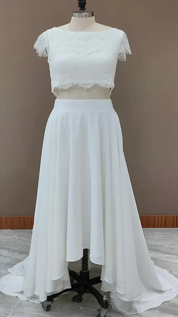 Manequin in bohemian two piece wedding gown featuring a high-low chiffon skirt and a fully laced top.