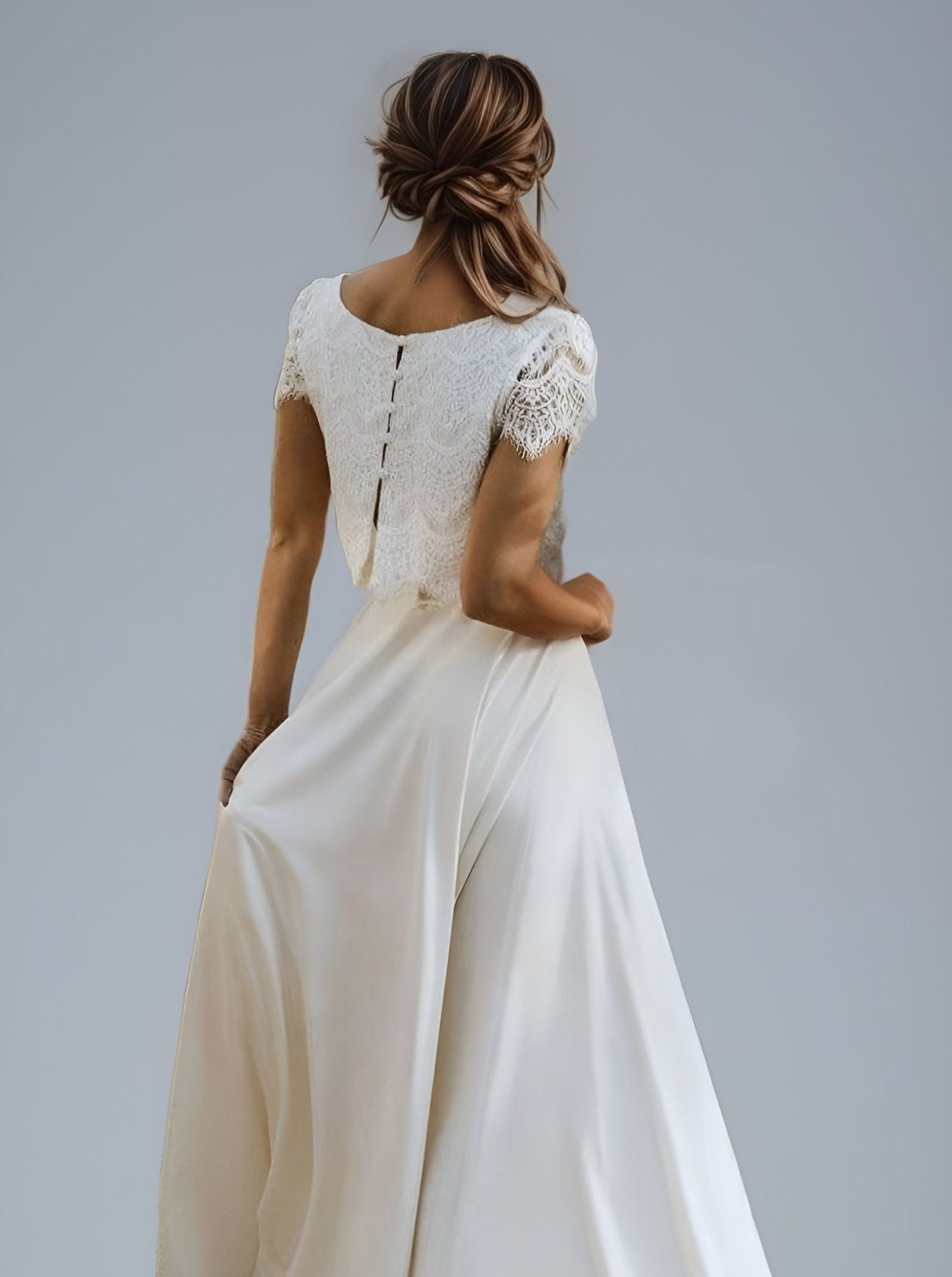 Bridal dress with a high-low skirt design: midi in the front and long with a train in the back.