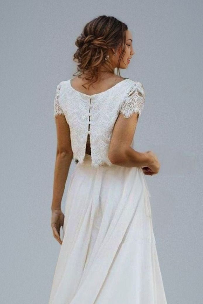 Back detail of chic bridal gown featuring a laced top with cap sleeves and a button-back design, perfect for a sophisticated boho wedding.