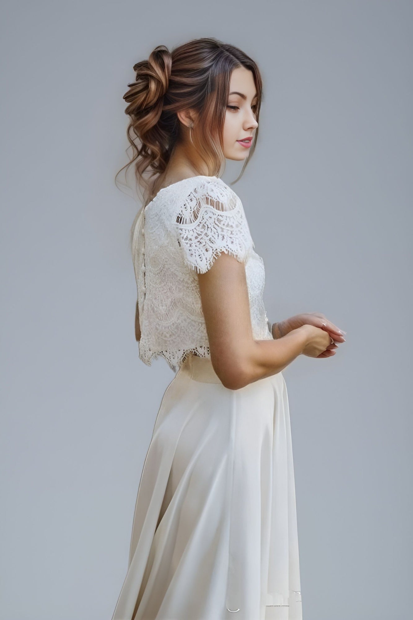 Stylish two-piece wedding dress with fully laced lace top and an A-line skirt, combining bohemian elegance.