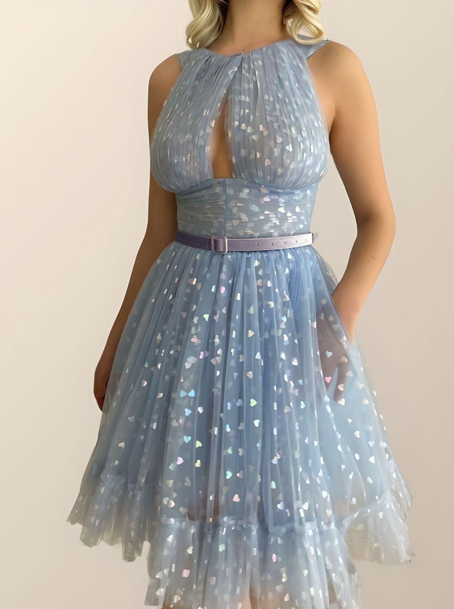 Sophisticated dress featuring tulle with shining hearts, belt and a tiered A-line skirt, perfect for a special celebration.