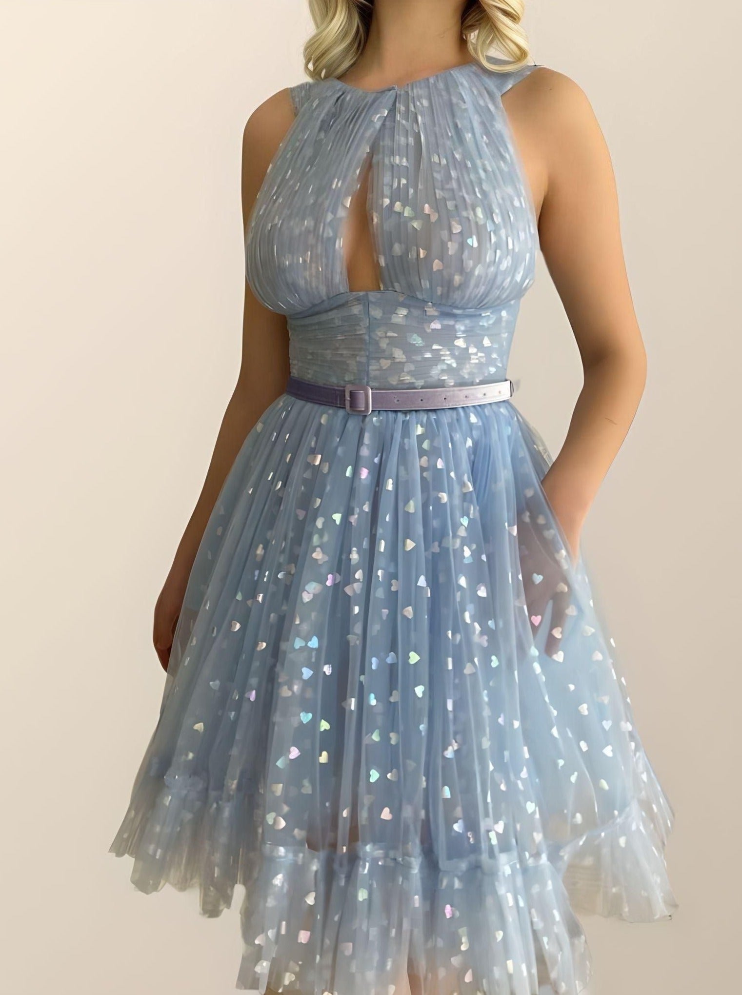 Sophisticated dress featuring tulle with shining hearts, belt and a tiered A-line skirt, perfect for a special celebration.