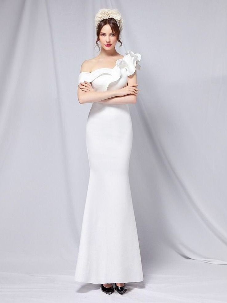Girl in white elegant formal gown with a trumpet silhouette, and ruffled one-shoulder design.