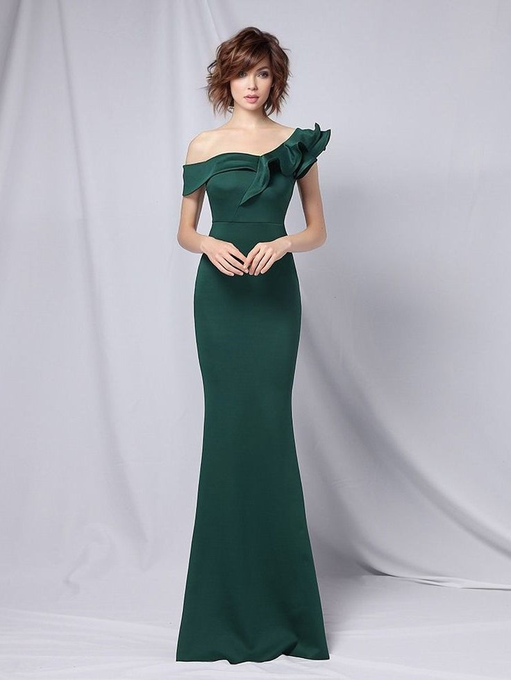 Woman in long Emerald Green dress with ruffled detailing and a one-shoulder design, ideal for special occasions or formal events.