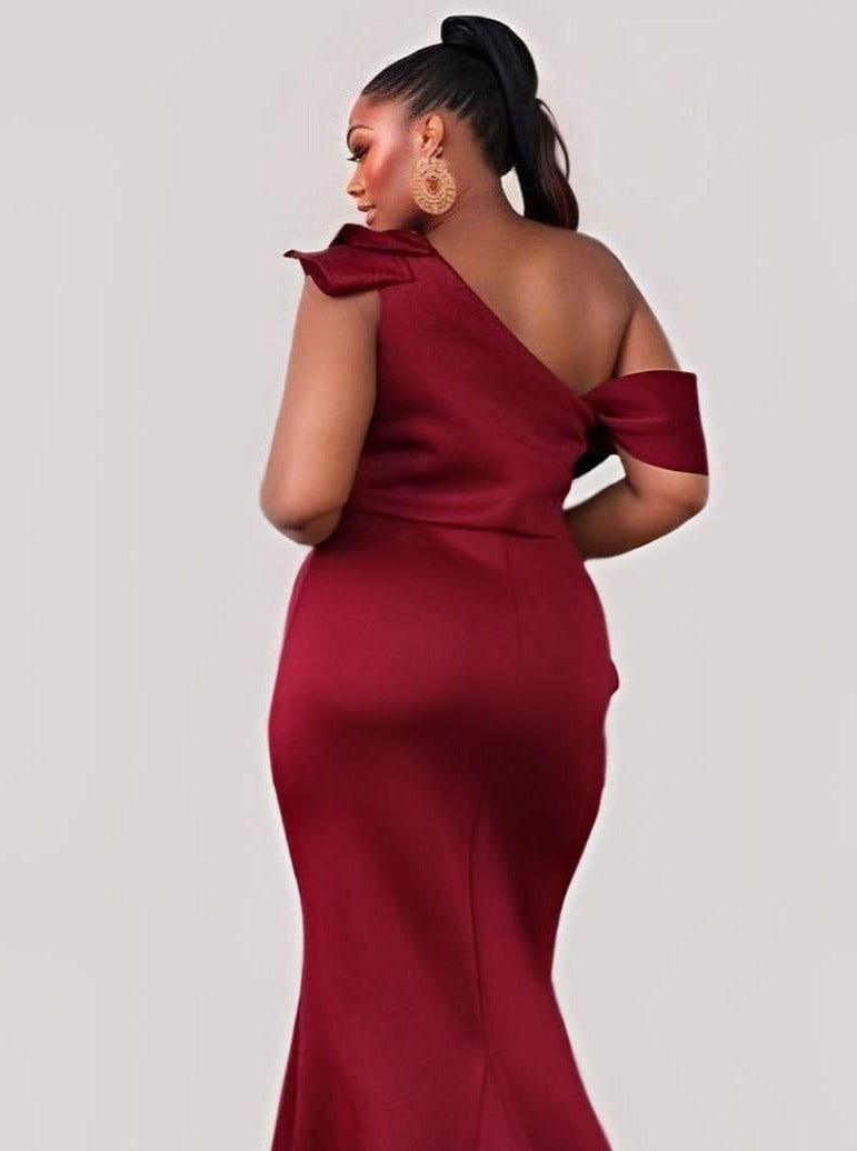 Plus size woman from back wearing burgundy one shoulder evening formal dress.