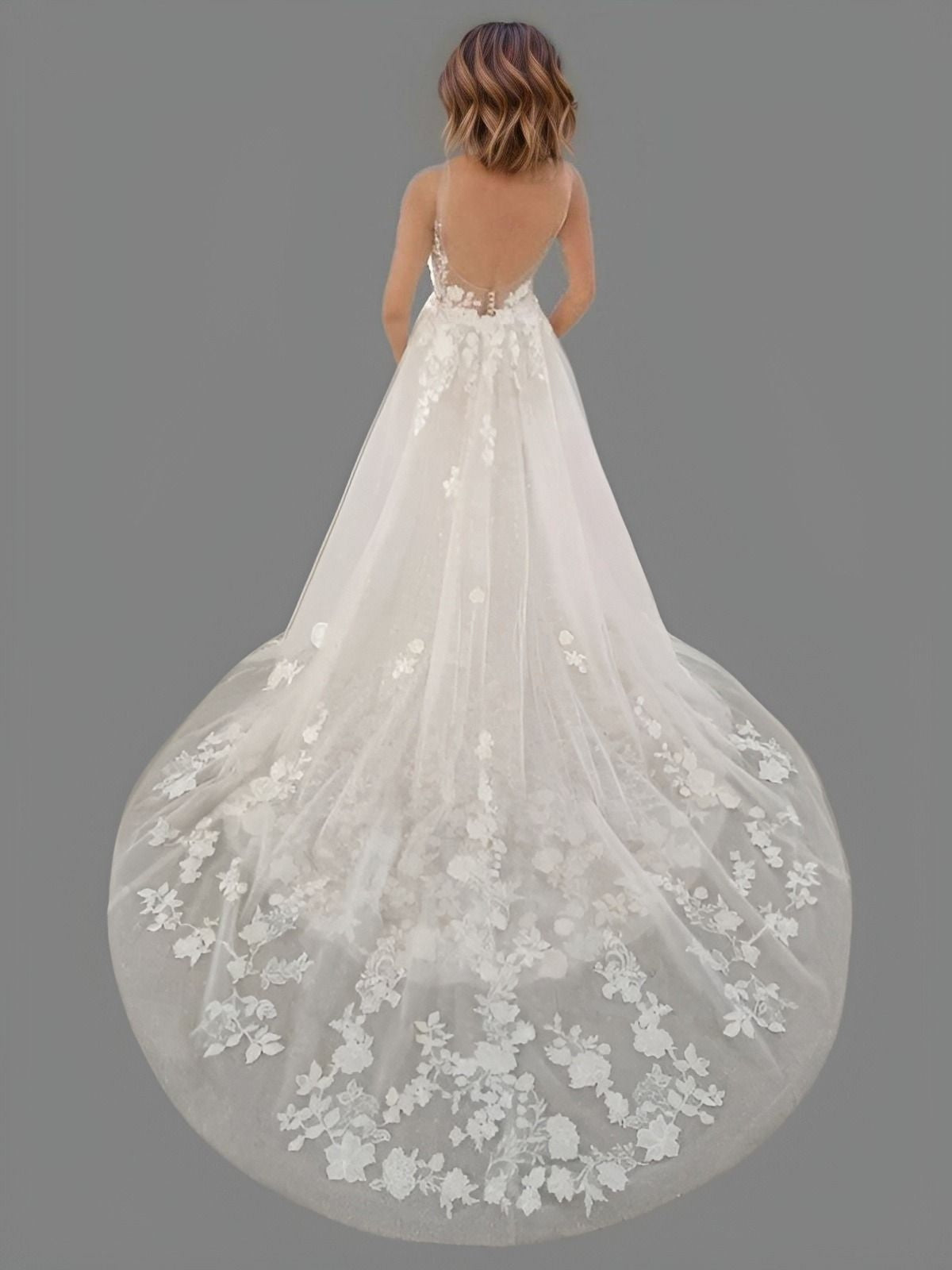 Bride showcasing a floral lace mermaid gown with a backless design, featuring a detachable A-line overskirt with lace train, offering two stunning looks in one.