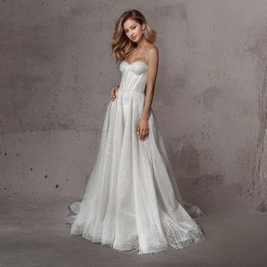 Bride showcasing a fully glittered tulle wedding gown with a sweetheart neckline, perfect for a glamorous bridal look.