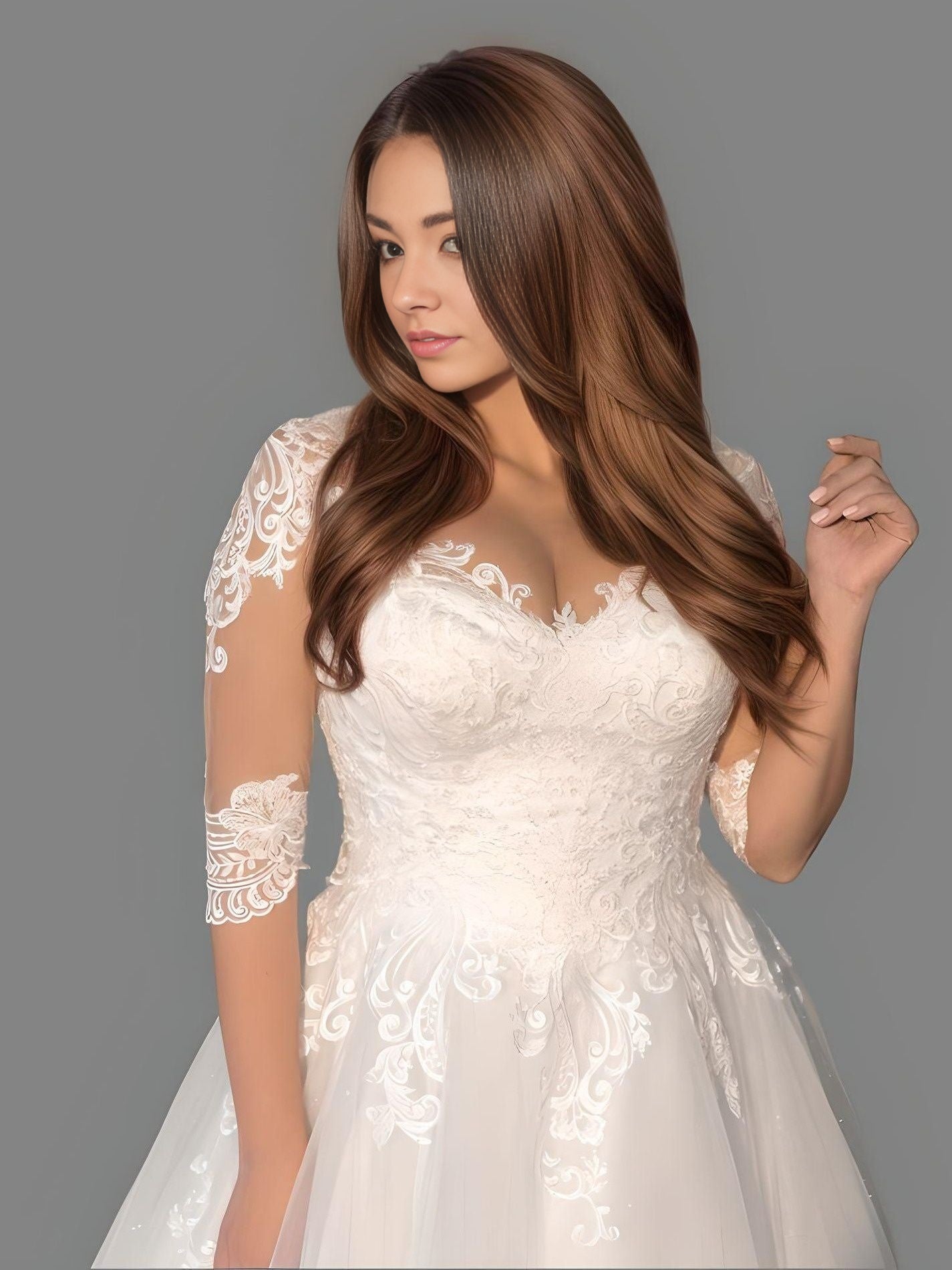 Close up of a bride wearing a tulle gown with lace appliques, V-neckline, and half sleeves, perfect for a romantic and sophisticated wedding style.