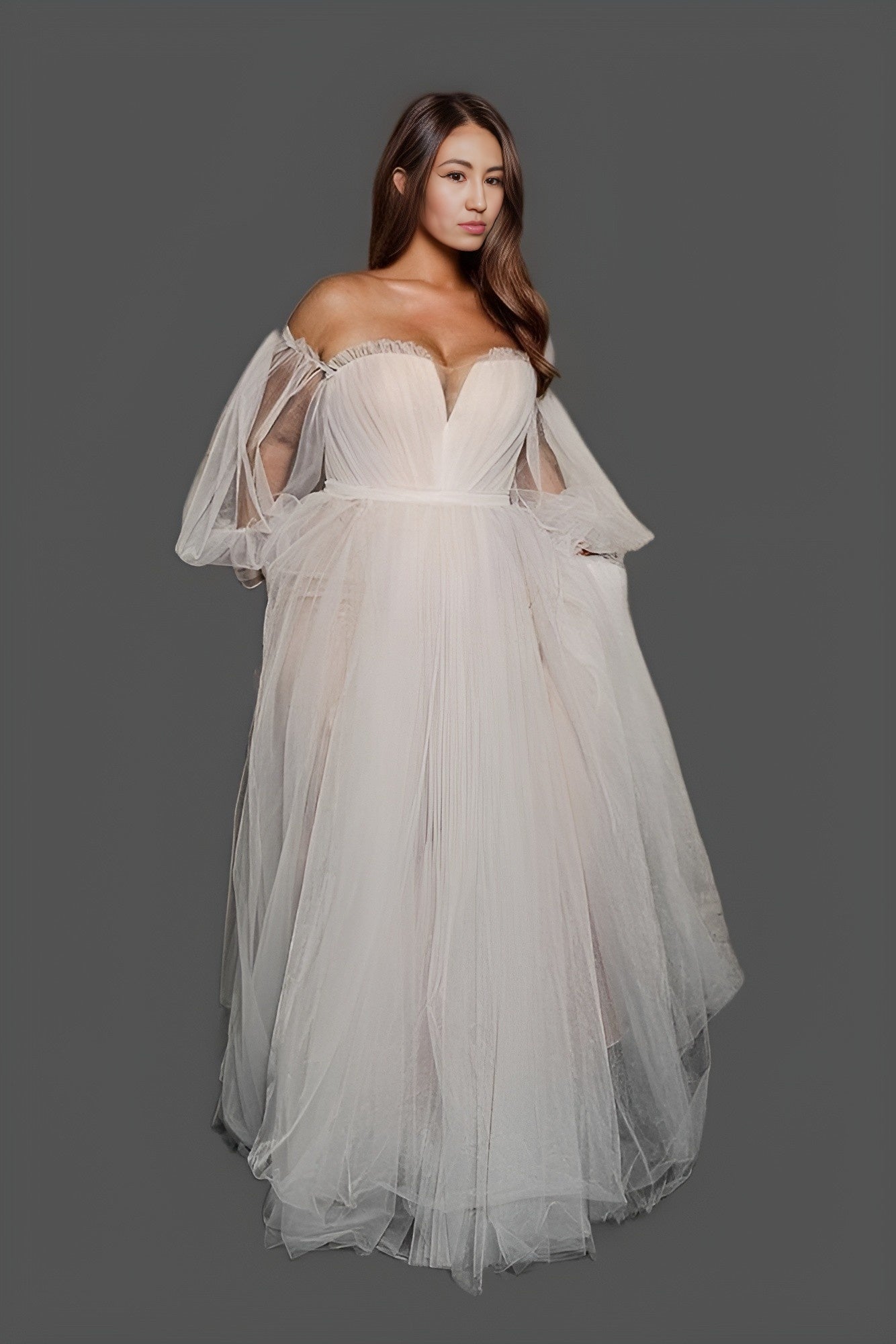 Elegant plus-size A-line gown featuring a boat neck, long puff sleeves, and a flowing sweep train, ideal for a stylish beach or garden wedding.