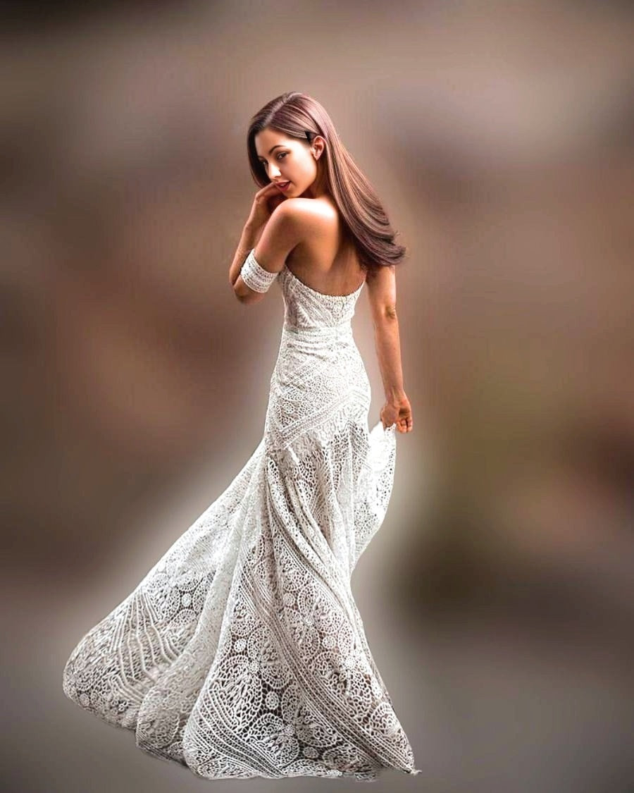 Bride wearing a gown with off-shoulder lace sleeves, sweetheart neckline, and fitted silhouette, ideal for a boho or beach wedding.