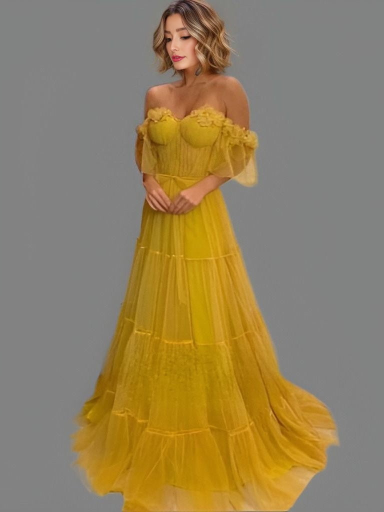 Bride or model in a yellow A-line prom dress featuring tiered tulle, 3D floral decorations, and an elegant sweep train, perfect for special events.