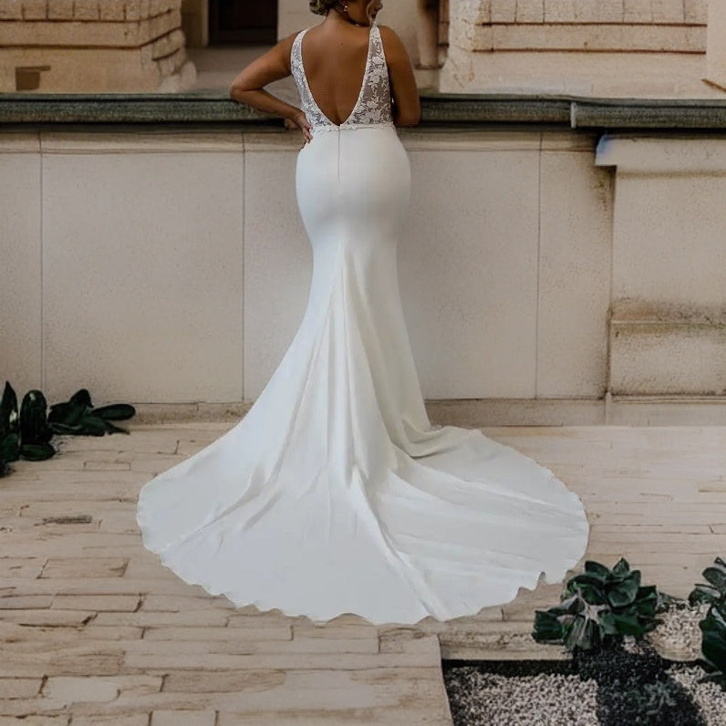 Model showcasing a satin mermaid wedding gown with lace appliques, and V backless design, perfect for a boho-chic bride.
