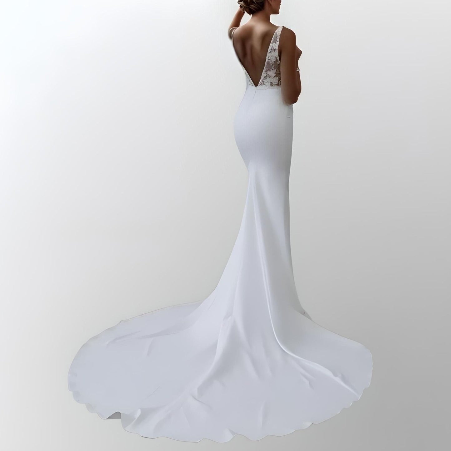 Bride wearing a handcrafted satin wedding dress with a backless design, straps, and lace details, ideal for an elegant and modern bridal look.