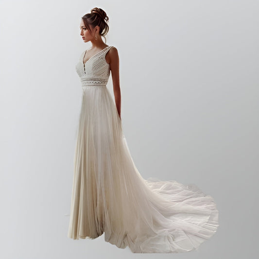 Model showcasing a bohemian-inspired wedding gown with a V-neckline, straight lace waist, and a flowing tulle A-line skirt with a sweep train.