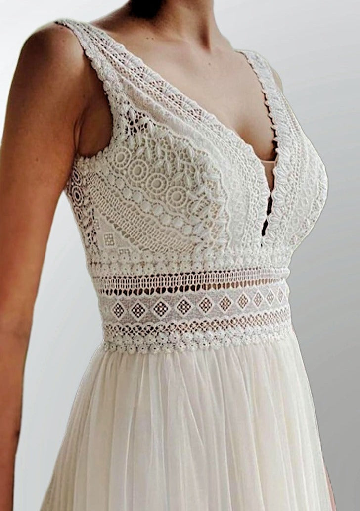 Close up of bride wearing a geometrical lace and tulle wedding dress with a V-neckline, accentuated waist, perfect for a romantic and bohemian wedding