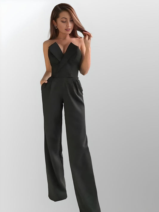 Woman in black strapless jumpsuit featuring an collared V neckline, and pockets, perfect for a contemporary wedding look.