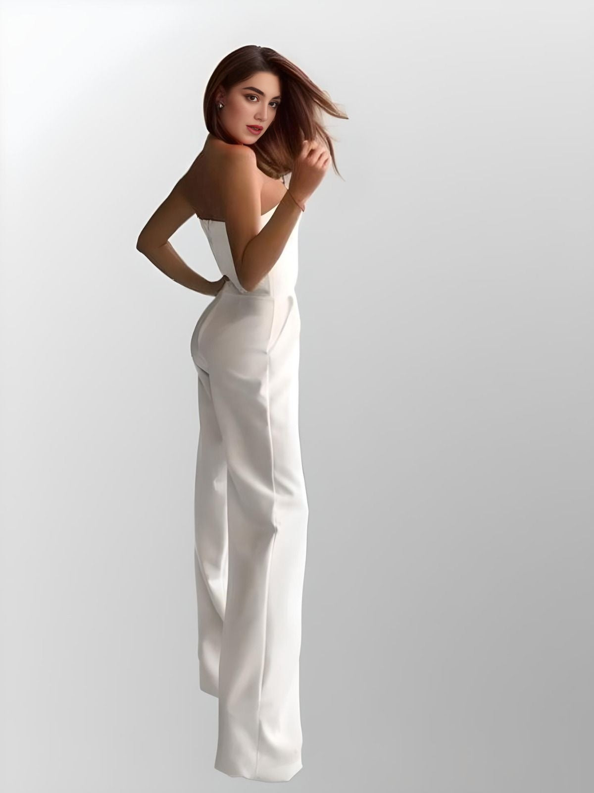 Elegant strapless jumpsuit from side with practical pockets, designed for a chic and sophisticated bridal or formal look.