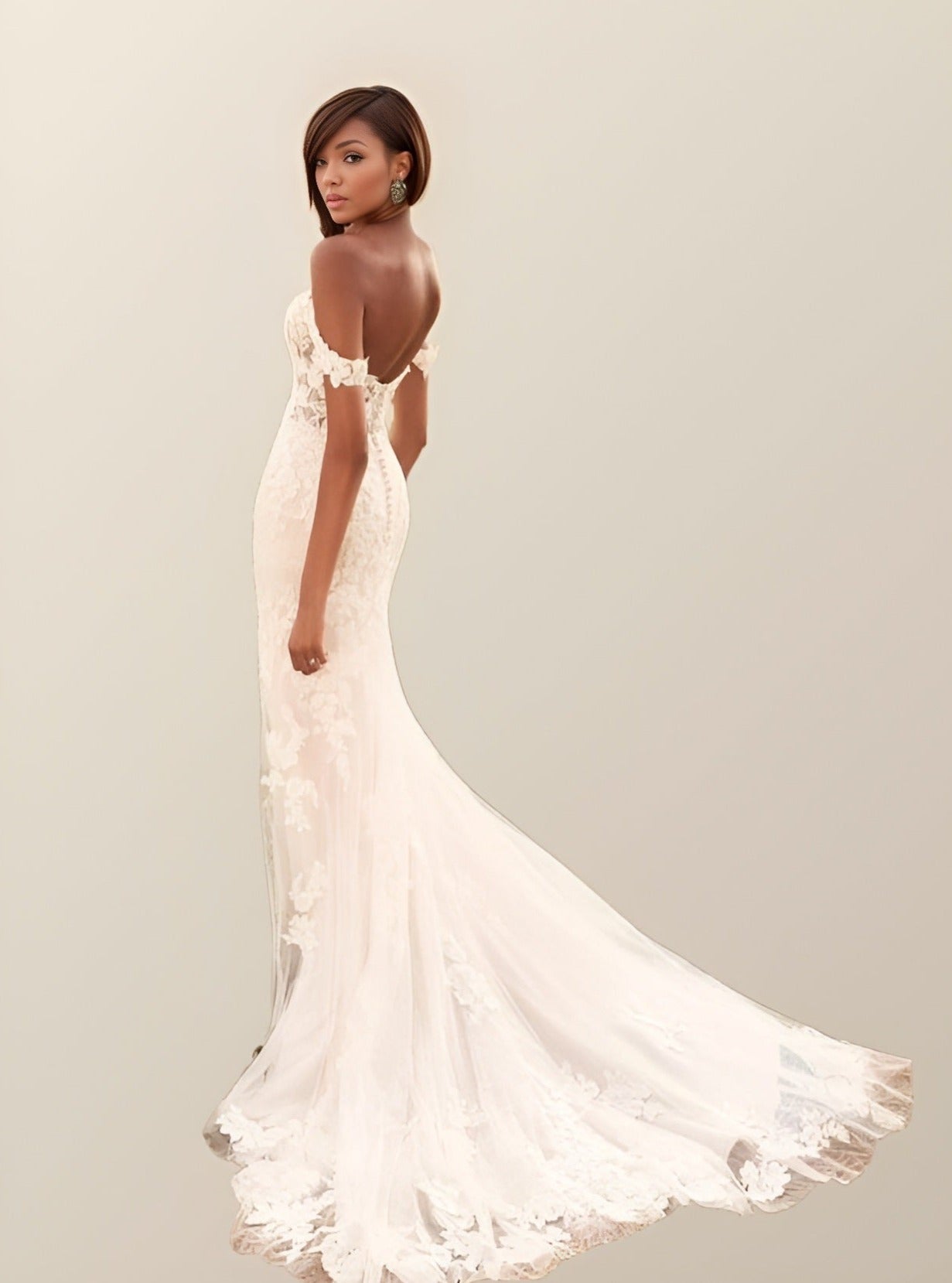 Elegant bohemian wedding dress featuring off-the-shoulder style, backless design and intricate lace, with a court train for a classic finish.