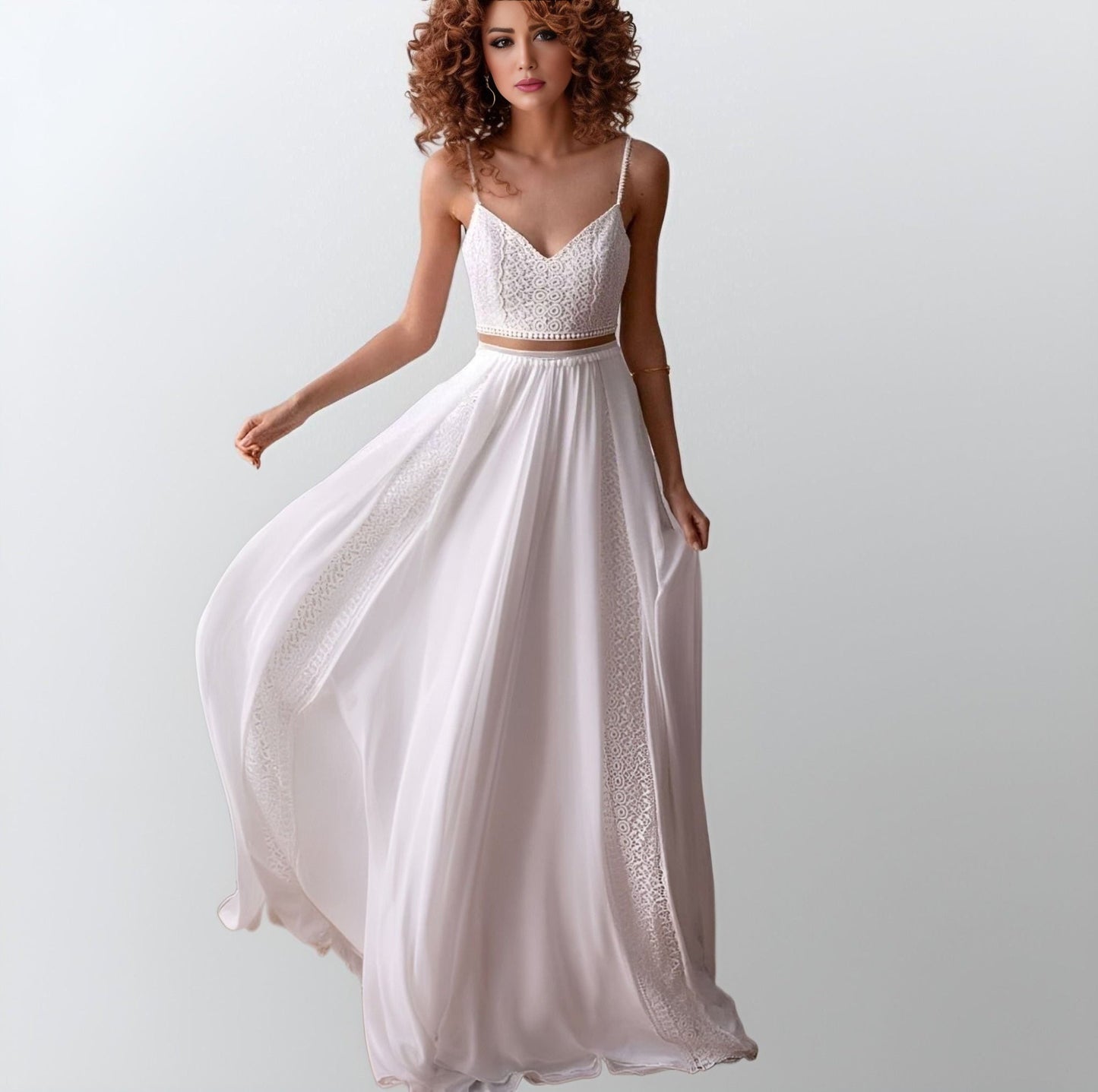 Bride showcasing a flowing chiffon wedding gown with an illusion lace top, spaghetti straps, and geometric lace detailing, perfect for a boho beach wedding.