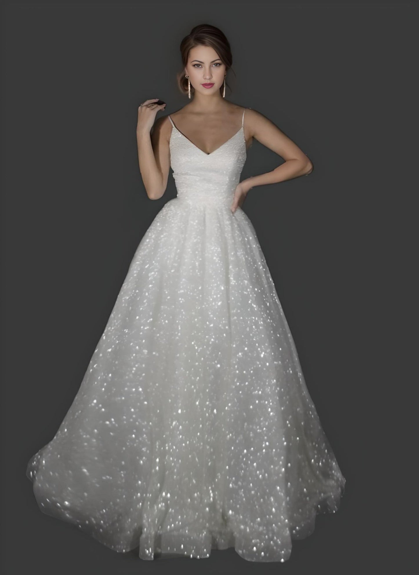 Bride wearing a floor-length sparkly wedding dress inwith spaghetti straps.