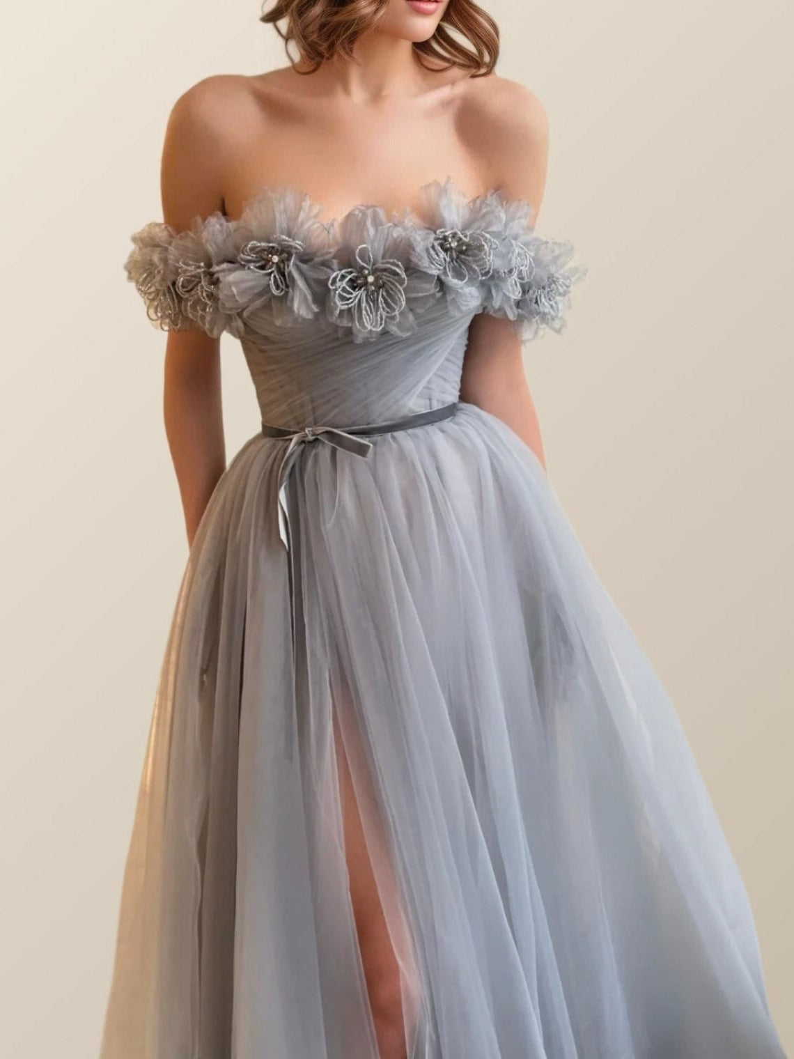 Close-up of 3D floral appliques on the LARA dress in soft silver color