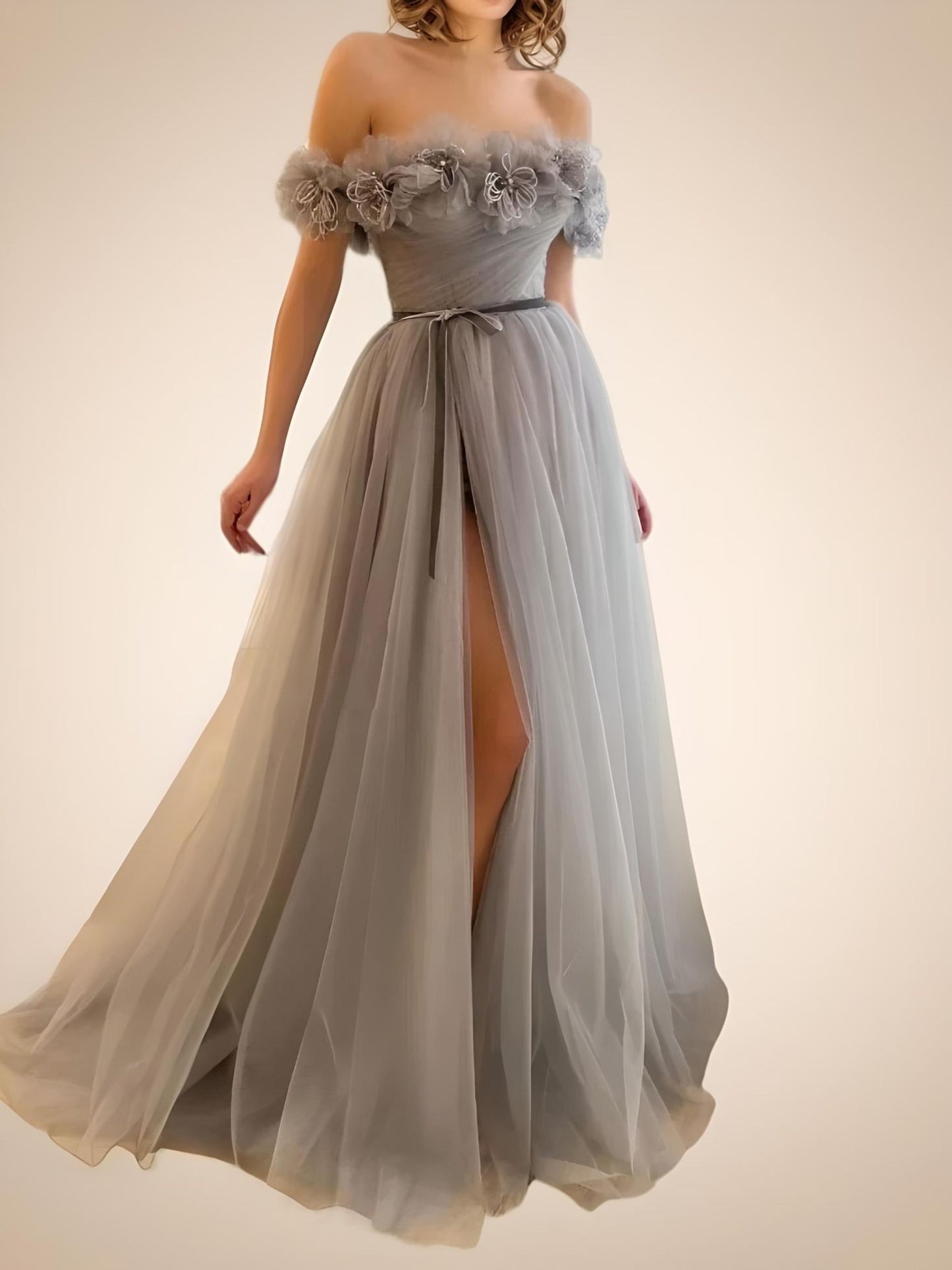 Woman wearing the LARA gown, emphasizing the elegant silver tulle and sleeveless design.