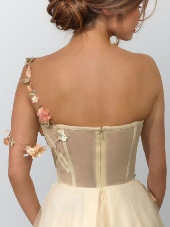 Woman in dress showing back view of LIBBY formal dress in champagne.