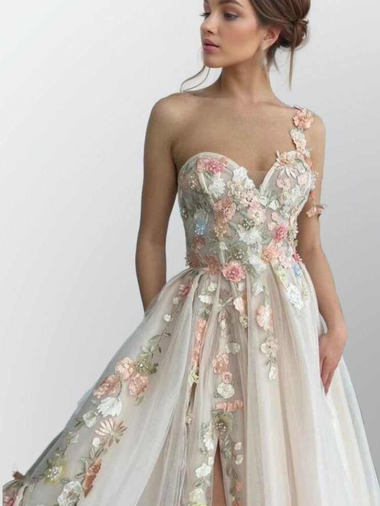 Close-up of sleeveless champagne dress bodice with delicate handmade flowers.